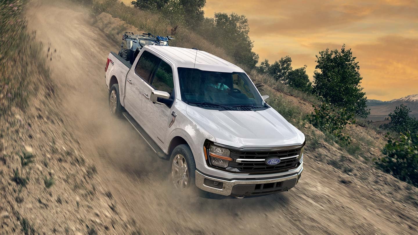 2024 Ford F150® PowerBoost® Hybrid pickup being driven on an open road